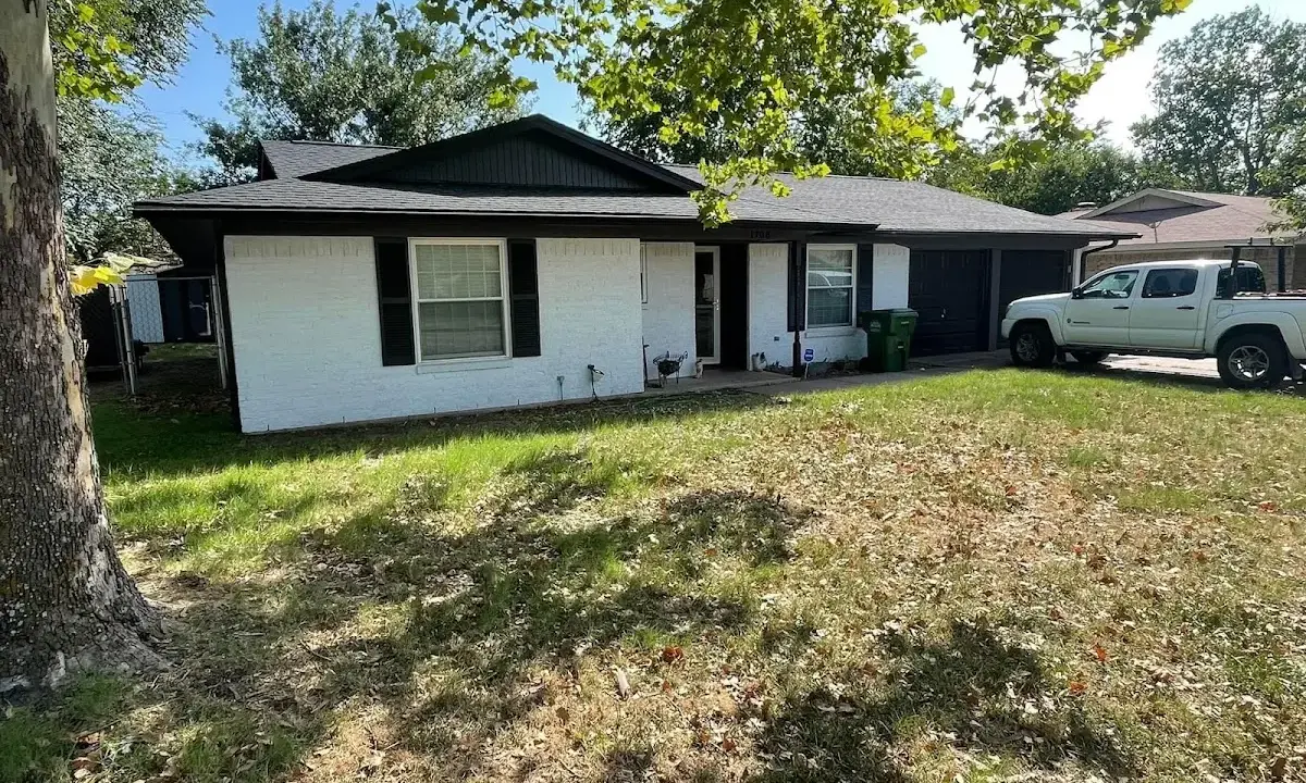 Professional roofing crew working on a residential roof in Lenox